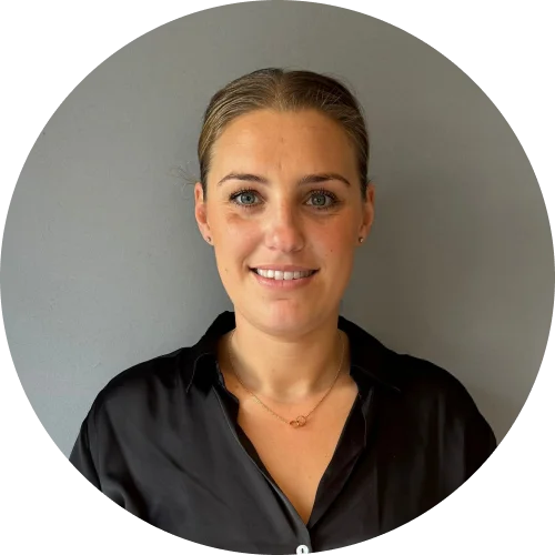 Abby Whiting, team member at T.M.S. Mechanical Services, smiling in a black shirt against a neutral background, representing the company's commitment to quality service in plumbing and heating.