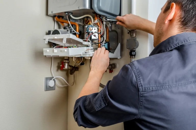 Technician repairing a gas boiler, focusing on internal components and wiring, illustrating boiler maintenance services.