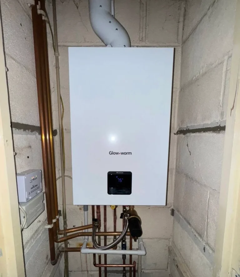 Glow-worm boiler installed in a residential setting, showcasing modern heating technology and plumbing connections, relevant to boiler installation and maintenance services in Essex.