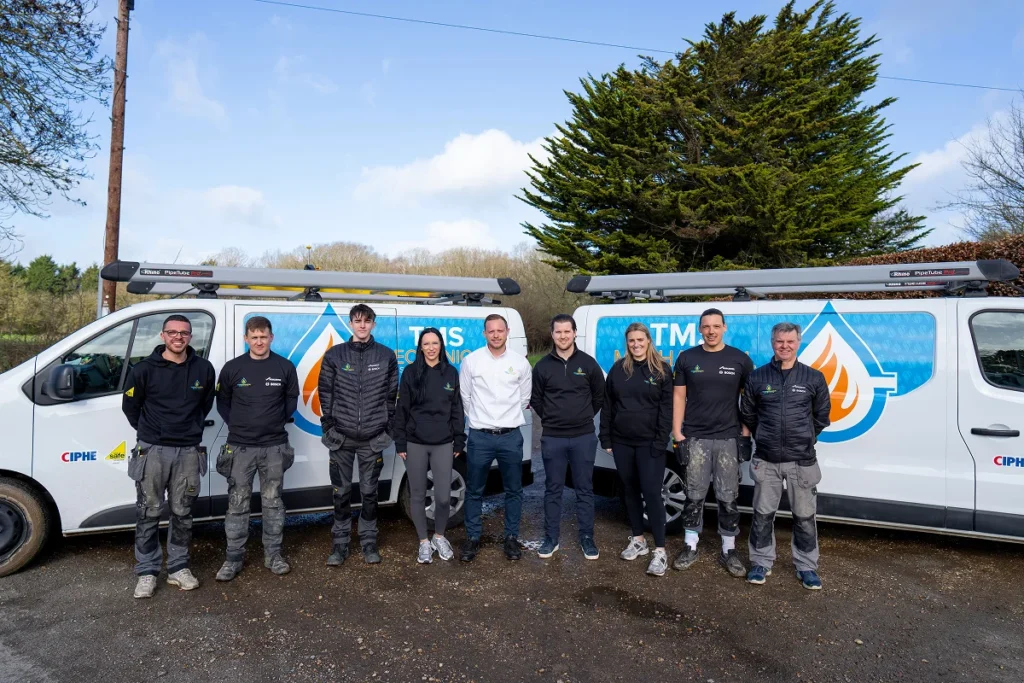 Team of TMS Mechanical Services standing in front of branded van, showcasing local heating experts in Essex, with emphasis on gas heating services and customer satisfaction.